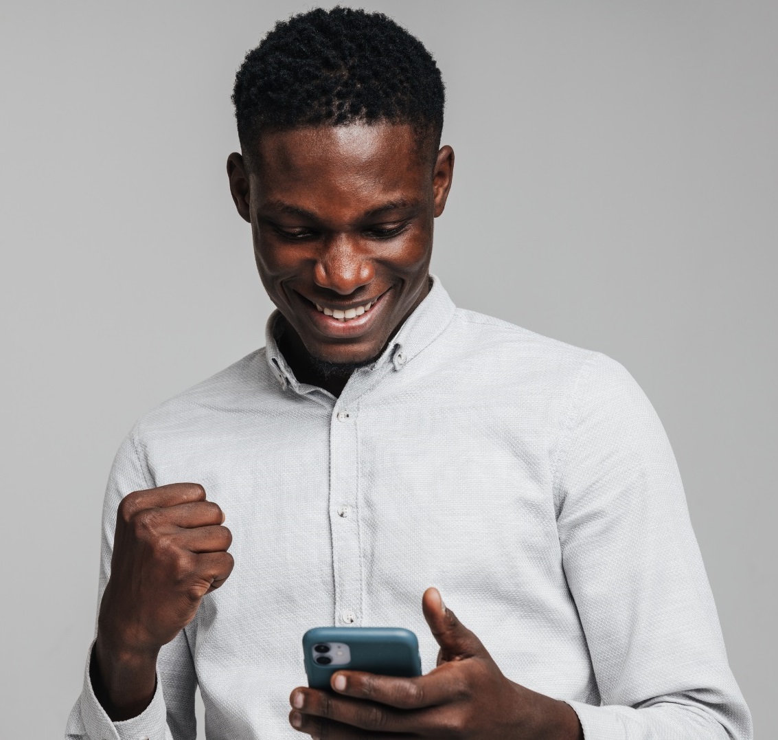 picture of a guy excited looking at his mobile phone